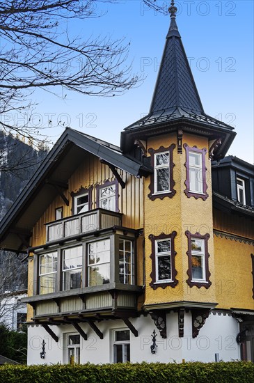 House with wooden shingles and oriel turret