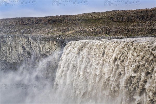 Hikers at the edge of Dettifoss