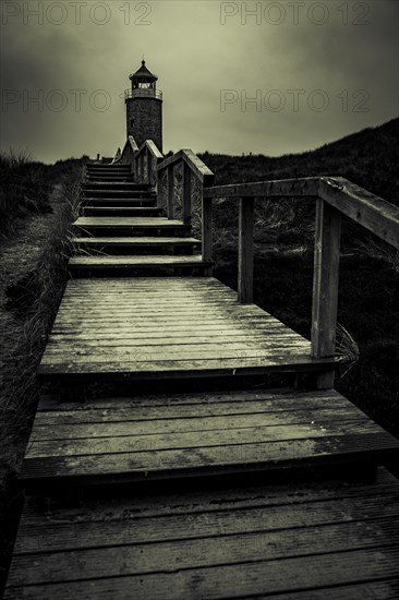 Cross light red cliff with wooden stairs