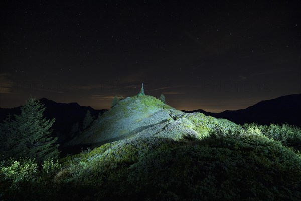 Peak lit by torch from Portlakopf