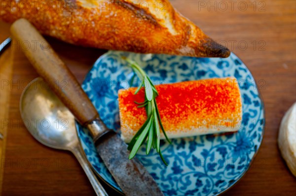 French cheese and fresh baguette on a wood cutter