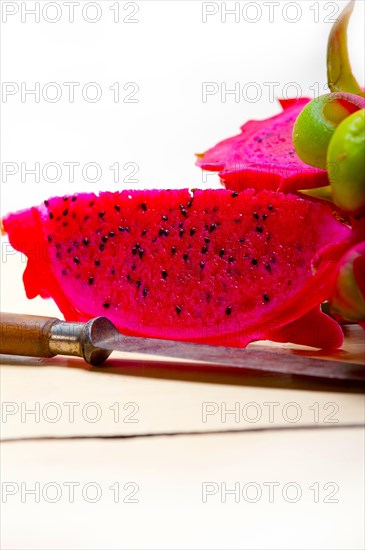 Fresh thai purple dragon fruit over white rustic table