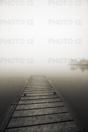 Abandoned bathing jetty in the morning mist