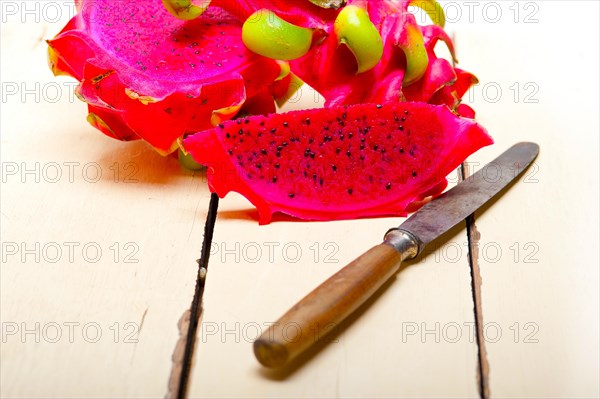 Fresh thai purple dragon fruit over white rustic table