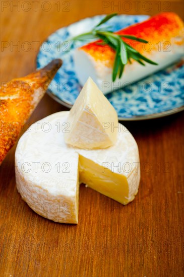 French cheese and fresh baguette on a wood cutter