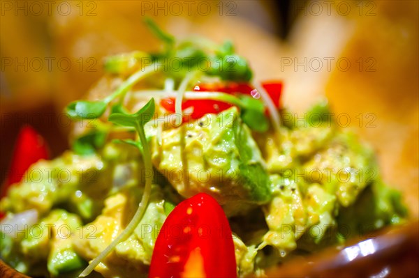 Fresh avocado and shrimps salad with nachos on side