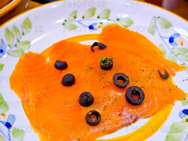 Norwegian smoked salmon with black olives on top