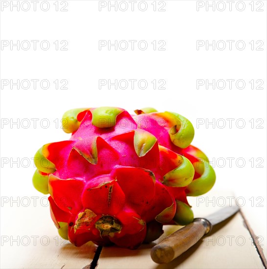 Fresh thai purple dragon fruit over white rustic table