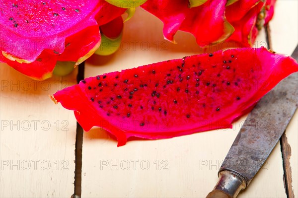 Fresh thai purple dragon fruit over white rustic table