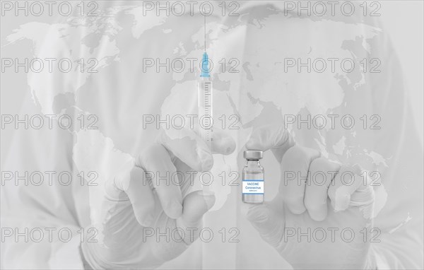 World map and doctor hands holding a vaccine bottle and syringe