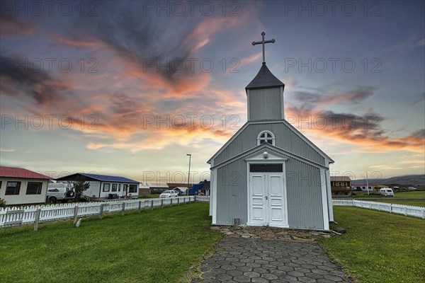 Grey wooden church and dwellings in the village