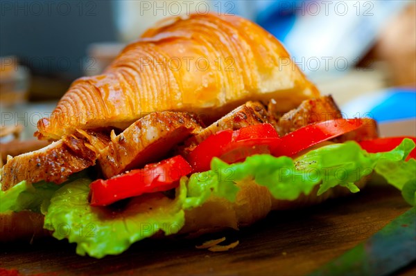 Savory croissant brioche bread with chicken breast and vegetable rustic style