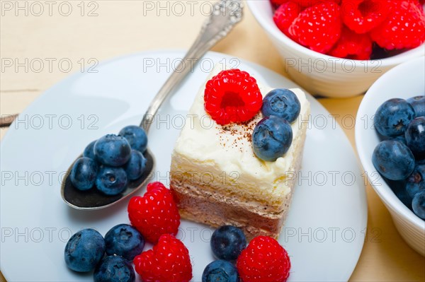 Fresh homemade raspberry and blueberry cream cake