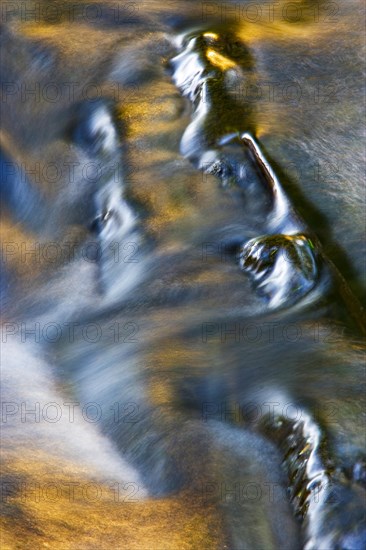 Flowing water with light reflections