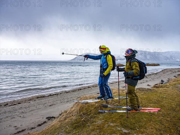 Mountain guide points towards the next destination to his guest