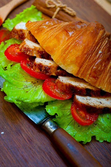 Savory croissant brioche bread with chicken breast and vegetable rustic style