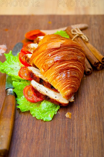 Savory croissant brioche bread with chicken breast and vegetable rustic style