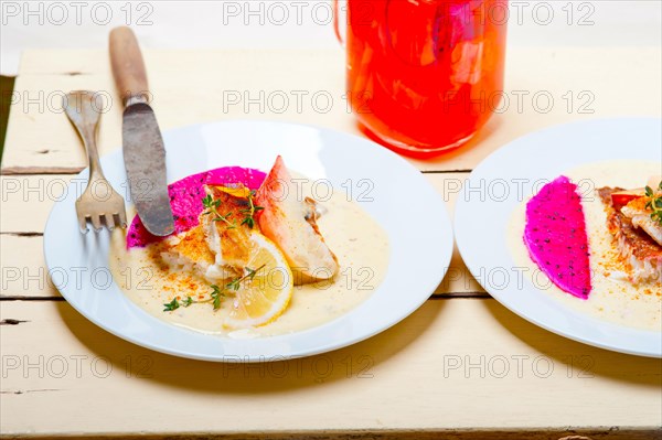 Sea bream orata fillet butter pan fried with fresh peach prune and dragonfruit slices thyme on top