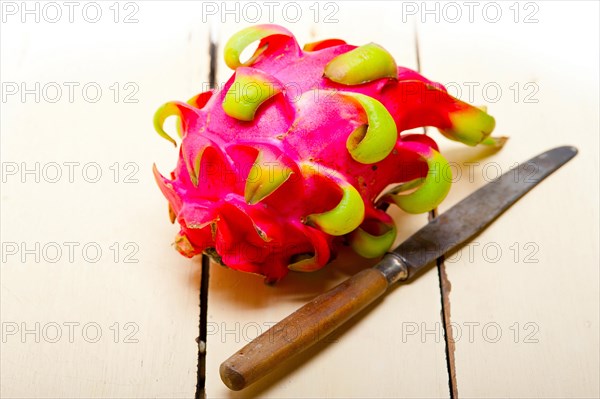 Fresh thai purple dragon fruit over white rustic table