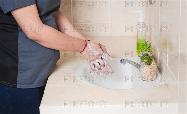 Close up of a person washing their hands with soap