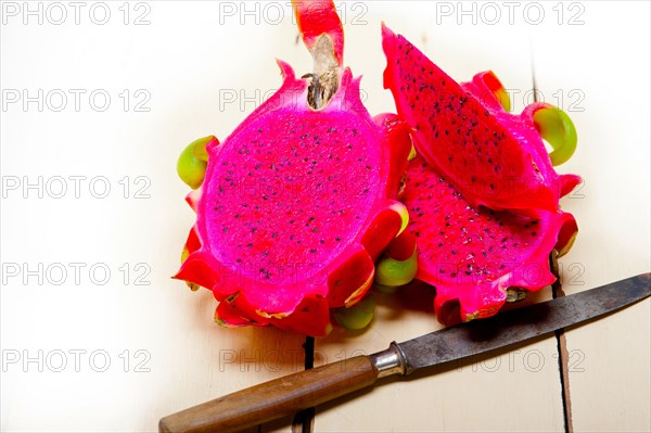 Fresh thai purple dragon fruit over white rustic table