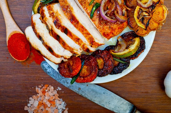 Roasted grilled BBQ chicken breast with herbs and spices rustic style