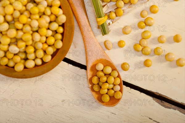 Organic soya beans over rustic wood table macro closeup