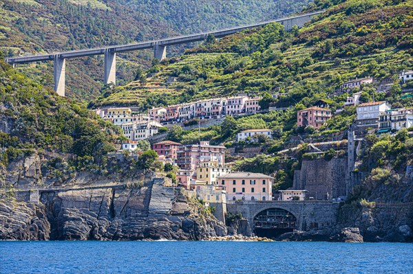 The village of Riomaggiore with its nested pastel-coloured houses built into the hillside