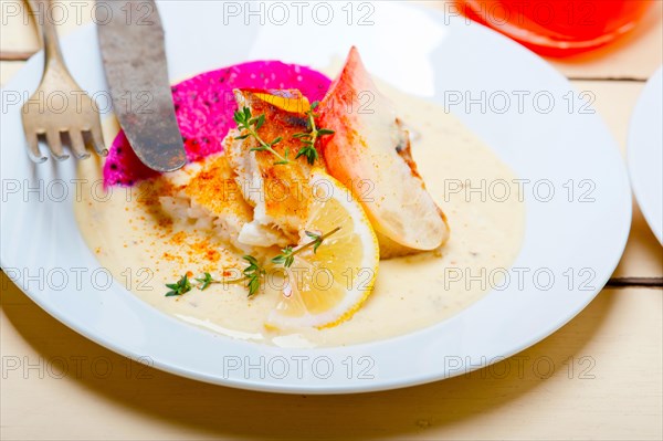 Sea bream orata fillet butter pan fried with fresh peach prune and dragonfruit slices thyme on top