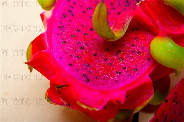 Fresh thai purple dragon fruit over white rustic table