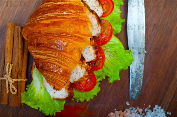 Savory croissant brioche bread with chicken breast and vegetable rustic style