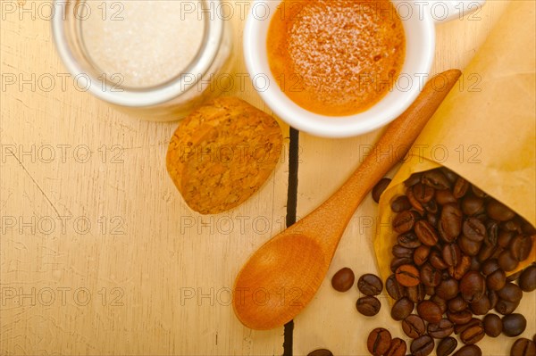 Espresso coffee and beans on a paper cone cornucopia over white background