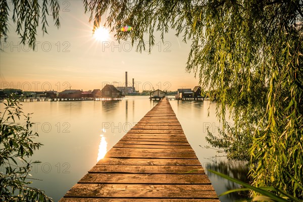 Small wooden houses with a jetty in a lake