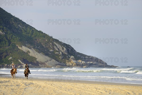 Two female riders on the beach