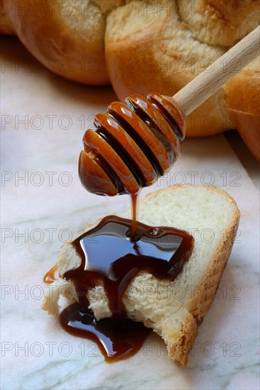 Yacon syrup drips onto a slice of yacon