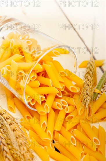 Short Italian pasta penne with durum wheat grains