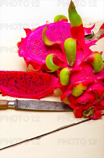 Fresh thai purple dragon fruit over white rustic table