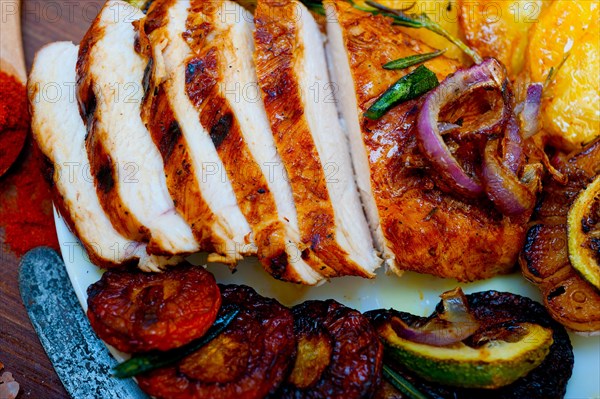 Roasted grilled BBQ chicken breast with herbs and spices rustic style