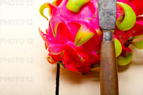 Fresh thai purple dragon fruit over white rustic table