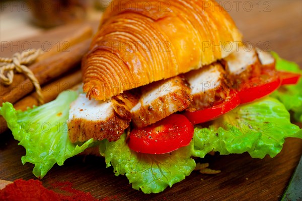 Savory croissant brioche bread with chicken breast and vegetable rustic style