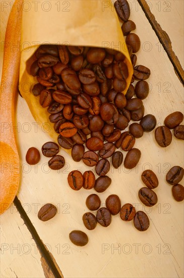 Espresso coffee and beans on a paper cone cornucopia over white background