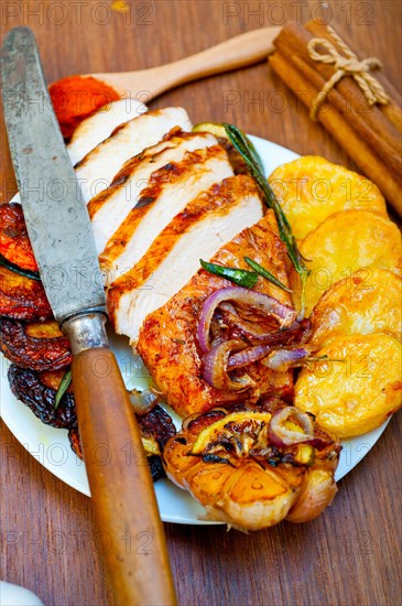 Roasted grilled BBQ chicken breast with herbs and spices rustic style