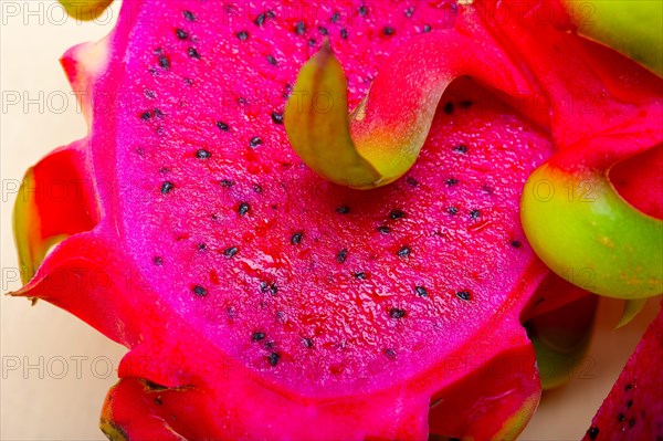 Fresh thai purple dragon fruit over white rustic table