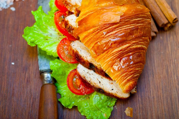 Savory croissant brioche bread with chicken breast and vegetable rustic style