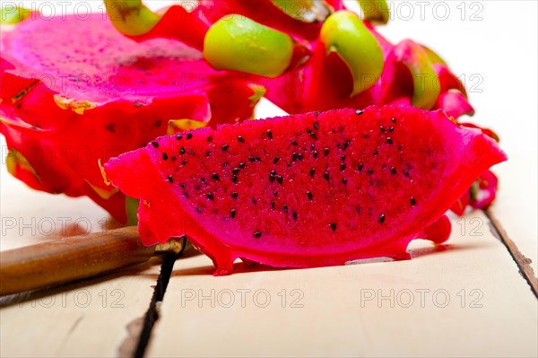 Fresh thai purple dragon fruit over white rustic table