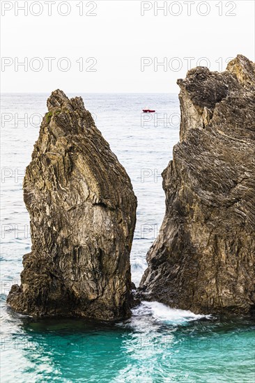 Boulders in the turquoise green sea