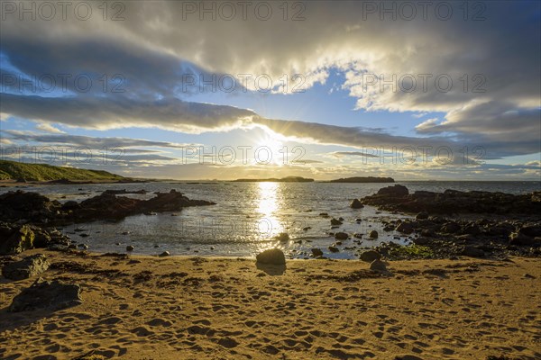 Bay with sand beach at sunset