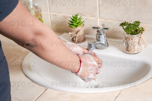 Close up of a person washing their hands with soap