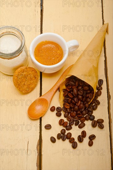 Espresso coffee and beans on a paper cone cornucopia over white background