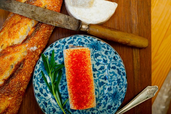 French cheese and fresh baguette on a wood cutter